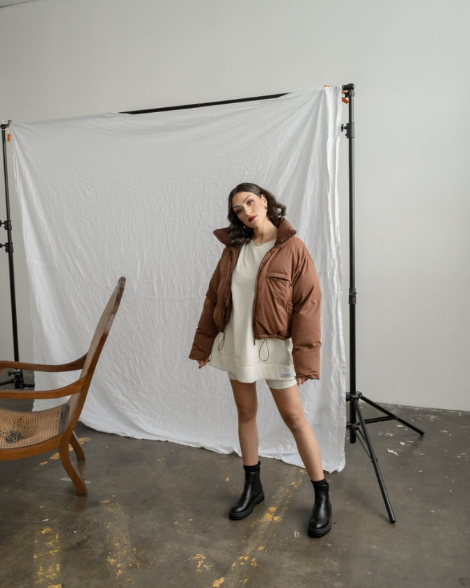Cropped chocolate brown puffer jacket worn my female model
