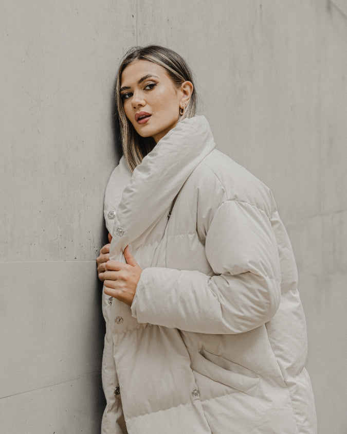 Stone longline puffer jacket worn by female model close up