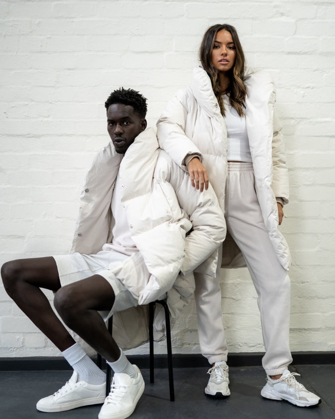 Stone longline puffer jacket worn by male and female model