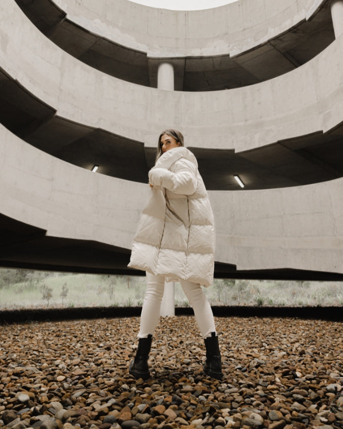 Stone longline puffer jacket worn by female model