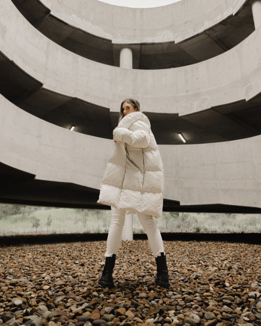 Stone longline puffer jacket worn by female model