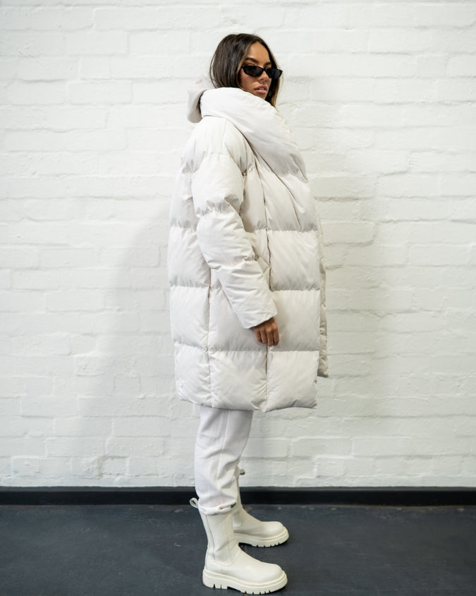 Stone longline puffer jacket worn by female model side view