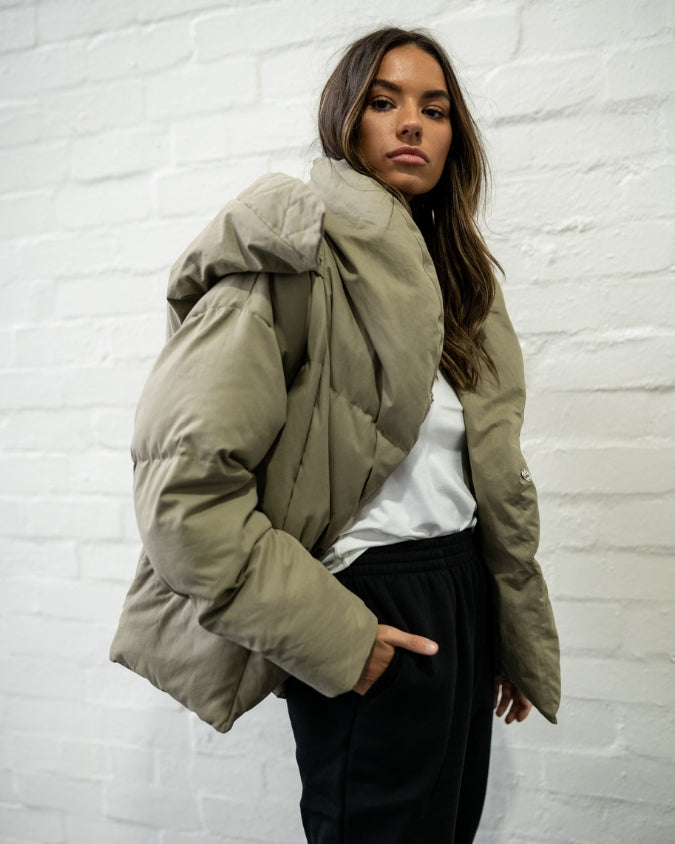 Close up of Khaki puffer jacket worn by female model