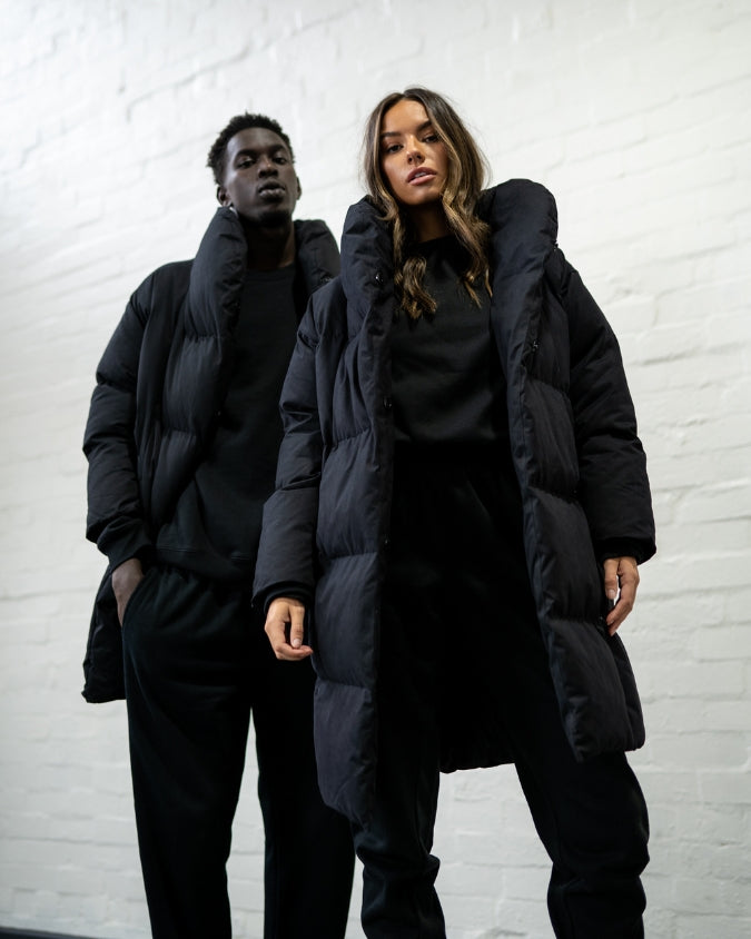Male and female model wearing black longline puffer jacket