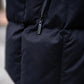 Close up of black puffer vest external zipper