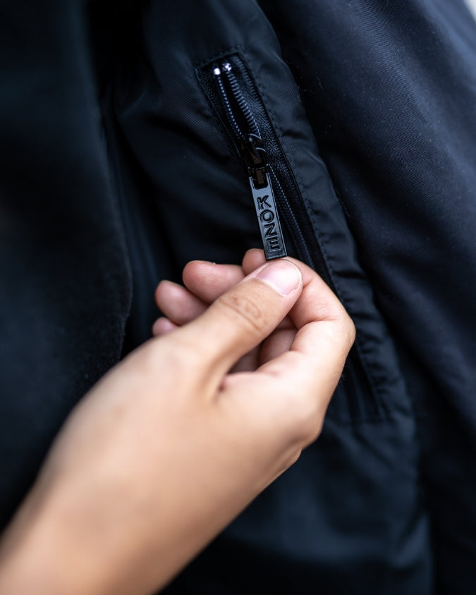 Close up of black puffer vest internal zipper
