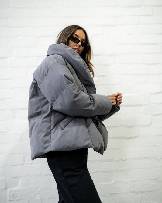 Charcoal puffer jacket worn by female model