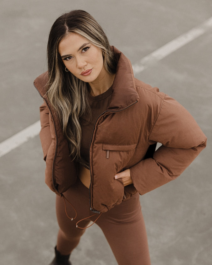 Chocolate cropped puffer jacket worn by female model