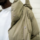 Close up of khaki puffer jacket snap button details