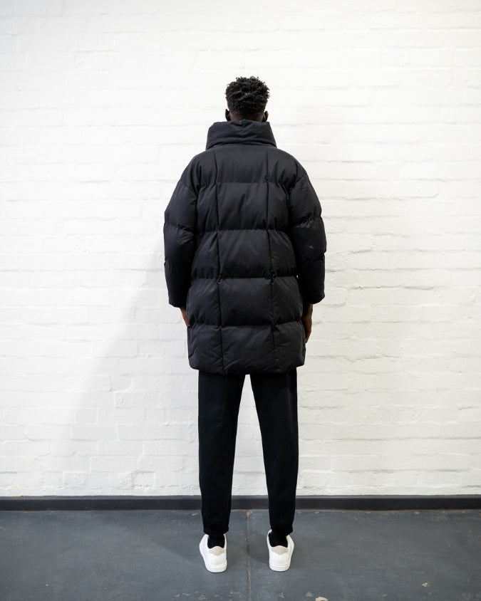 Australian black longline puffer jacket worn by male model back view