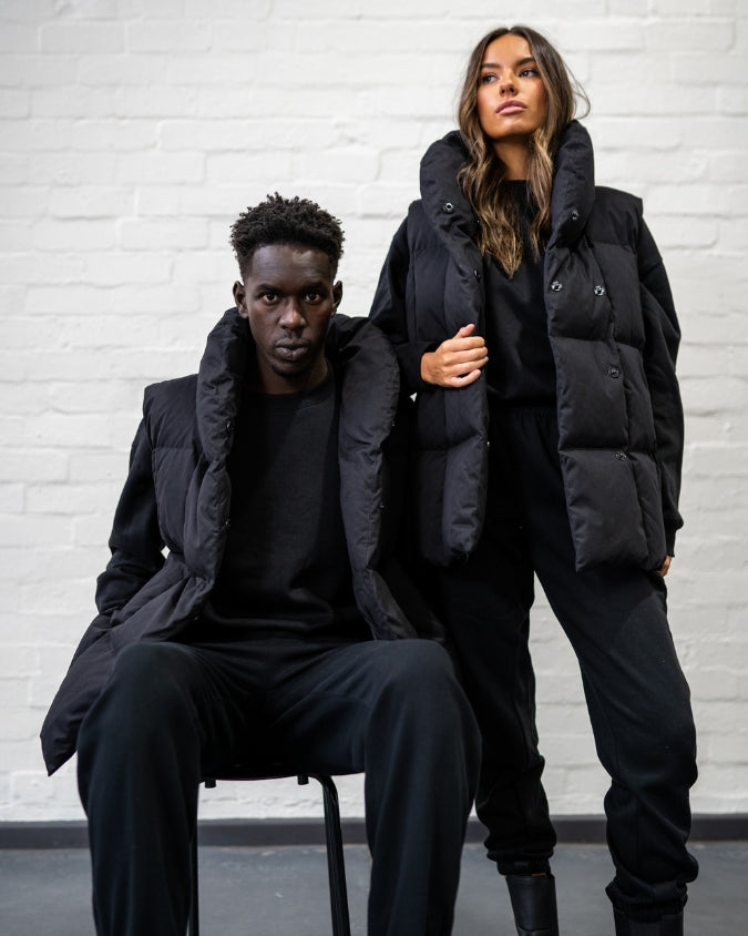 Black Longline Puffer Vest worn by male and female model