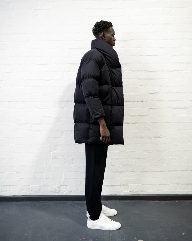 Australian black longline puffer jacket worn by male model side view