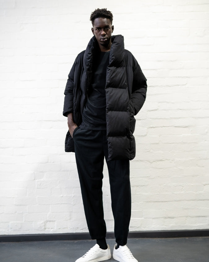 Australian black long puffer jacket worn by male model