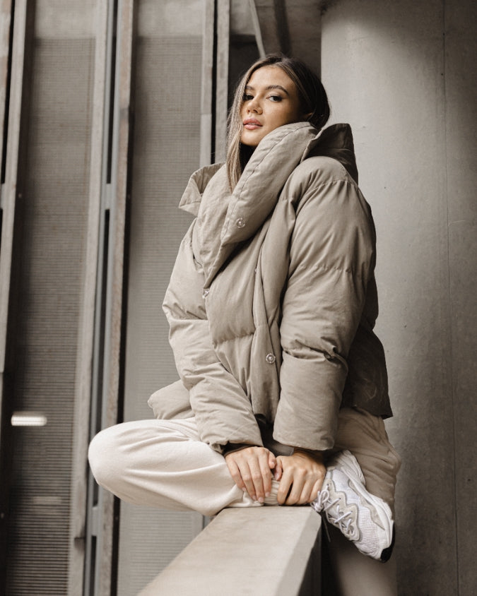 Oversized Khaki puffer jacket worn by female model