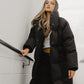 Australian black longline puffer jacket worn by female model