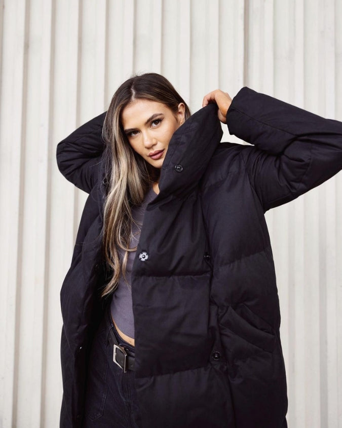 Black longline puffer jacket with high neck worn by female model